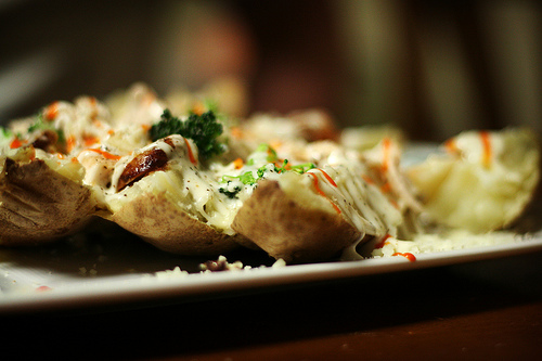 Baked Potatoes With Chive  And Cheese Topping 